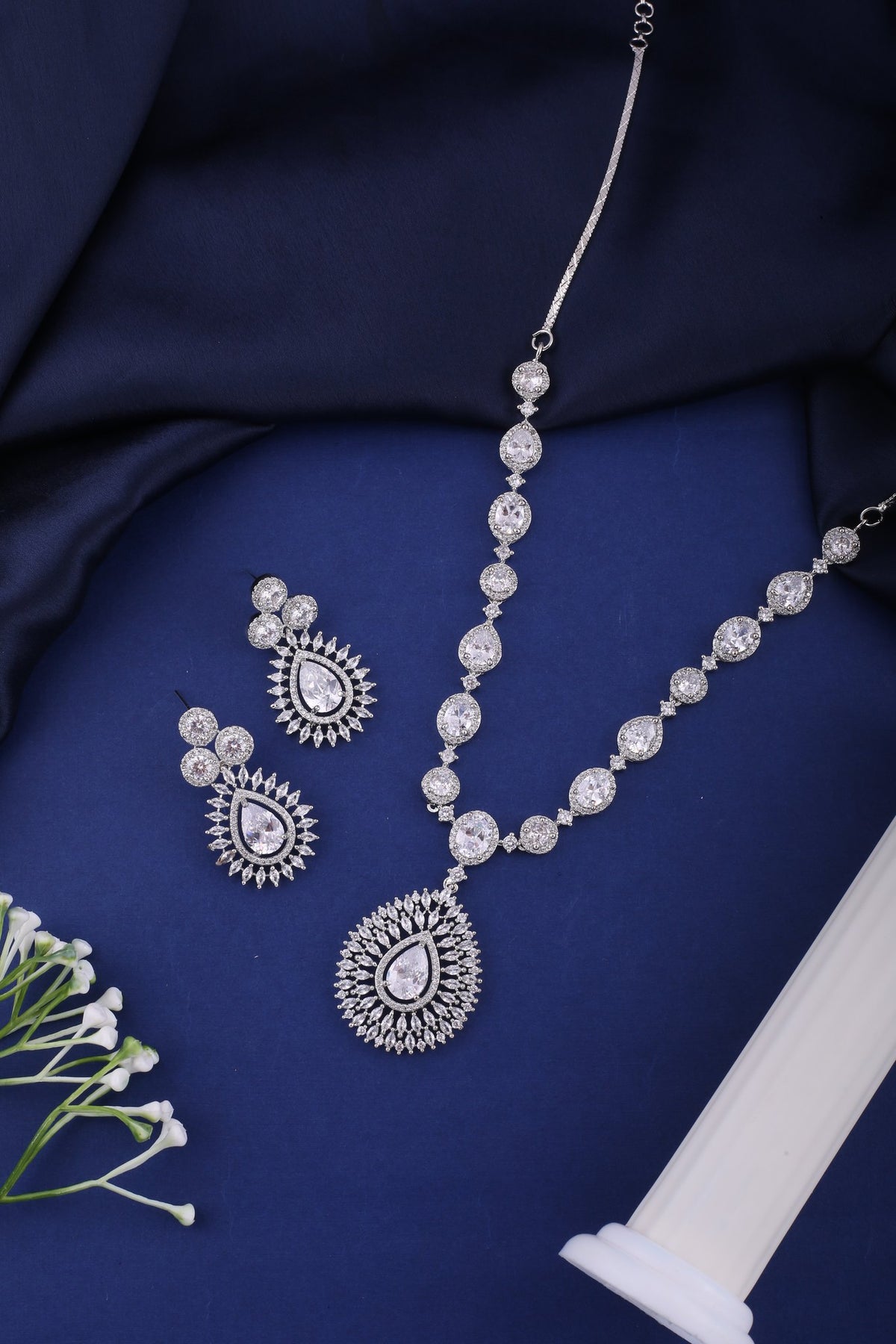 Clear American Diamond Teardrop Pendant Necklace Set, styled flat lay