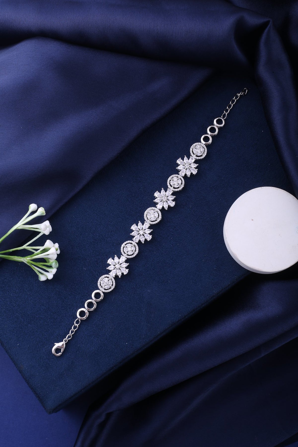 Silver Floral Cubic Zirconia Link Bracelet, styled flat lay