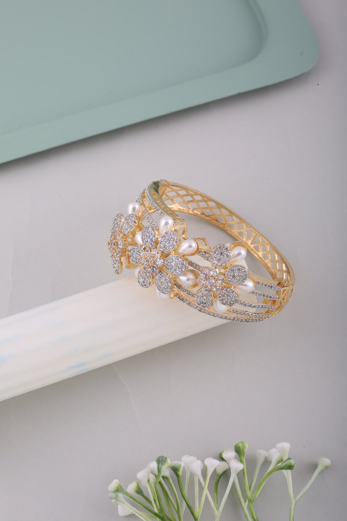 Pearl Flower American Diamond Kada - Gold, styled flat lay