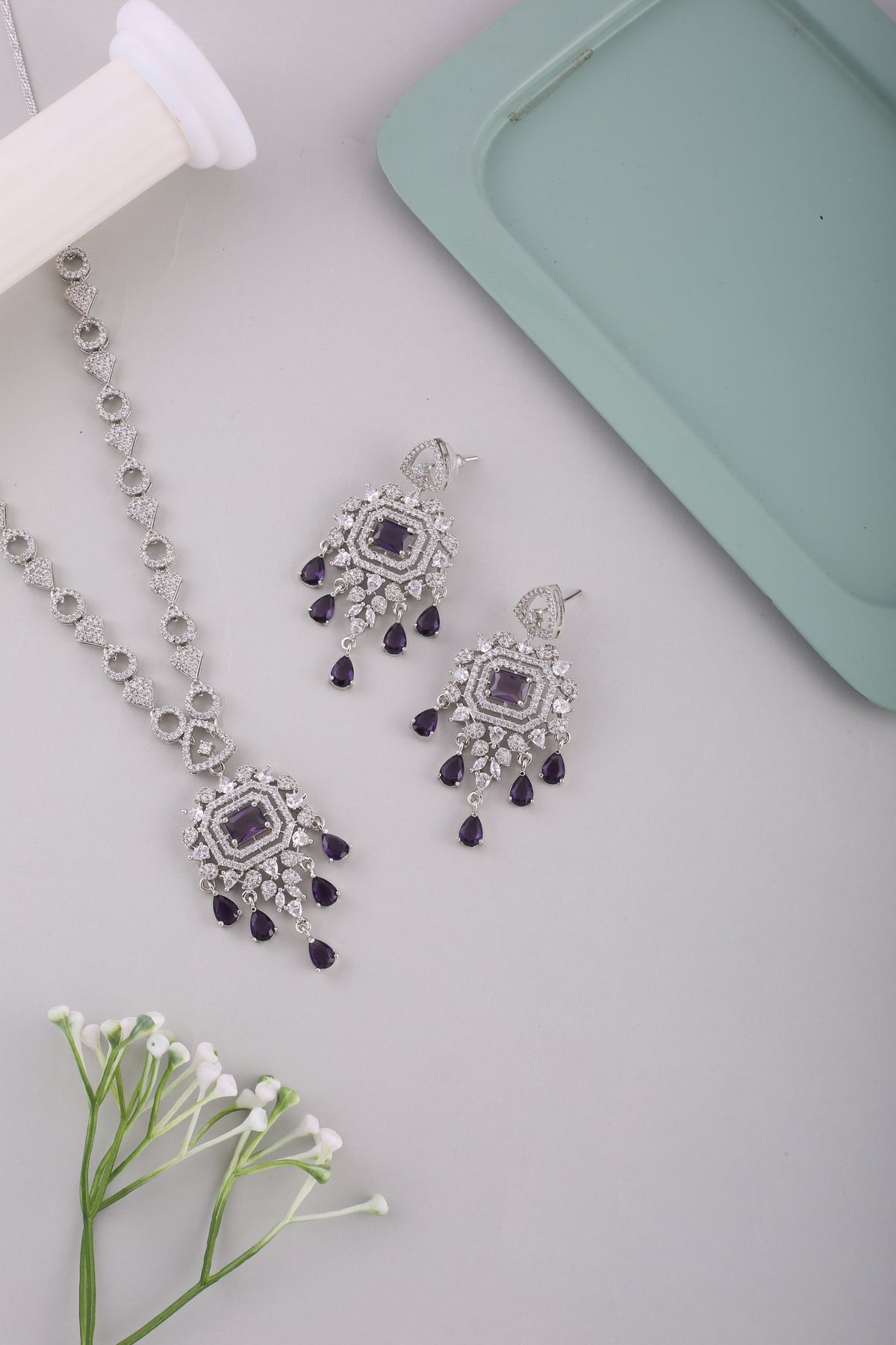 Amethyst Purple American Diamond Pendant Necklace Set with Chandelier Earrings, styled flat lay