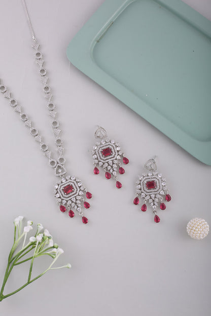 Ruby American Diamond Pendant Necklace Set with Chandelier Earrings, styled flat lay