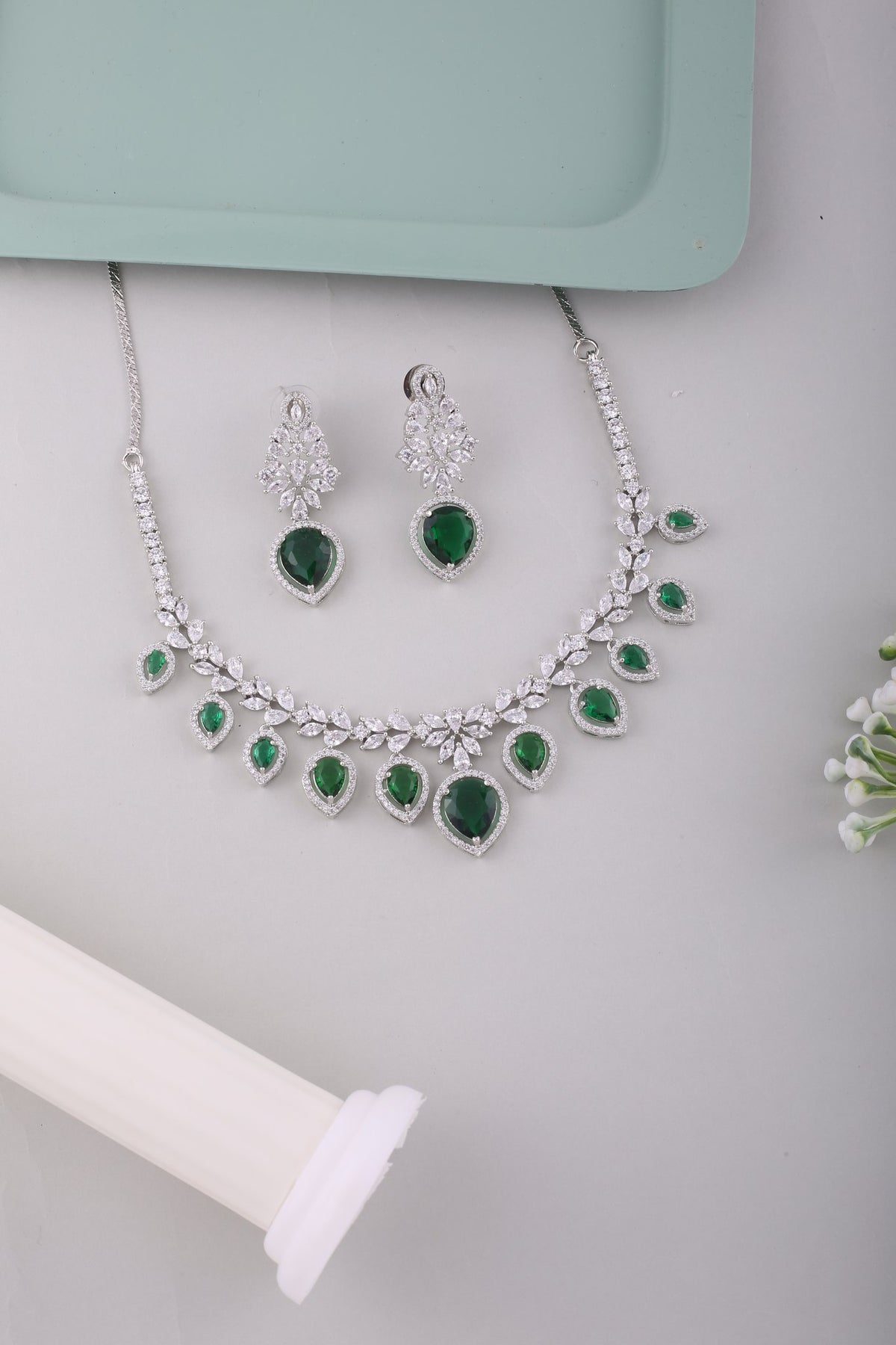 Emerald Green American Diamond Pear Drop Necklace Set, styled flat lay