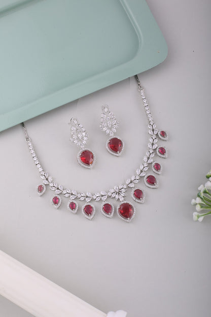 Ruby Red American Diamond Pear Drop Necklace Set, styled flat lay