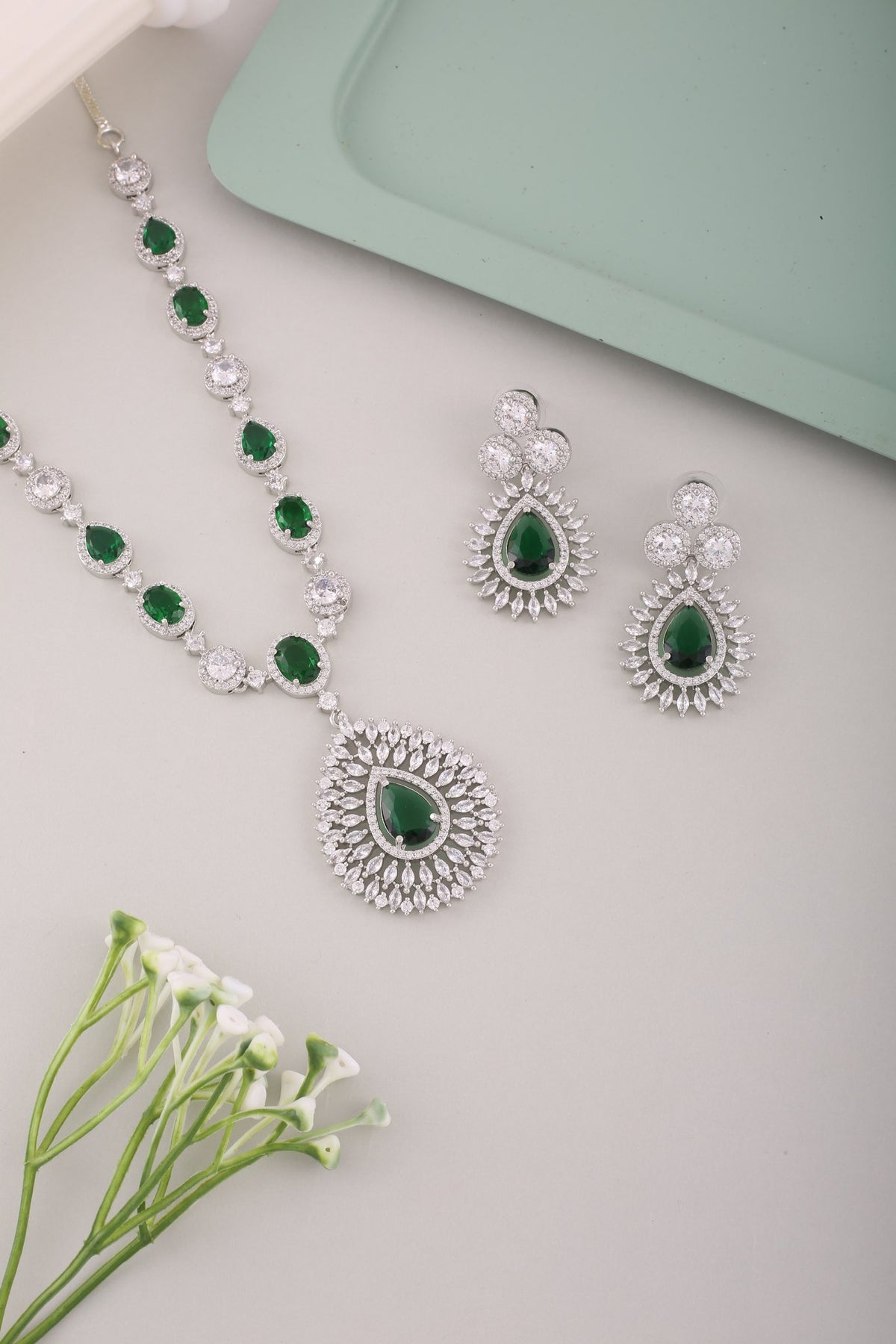 Emerald Green American Diamond Teardrop Pendant Necklace Set, styled flat lay