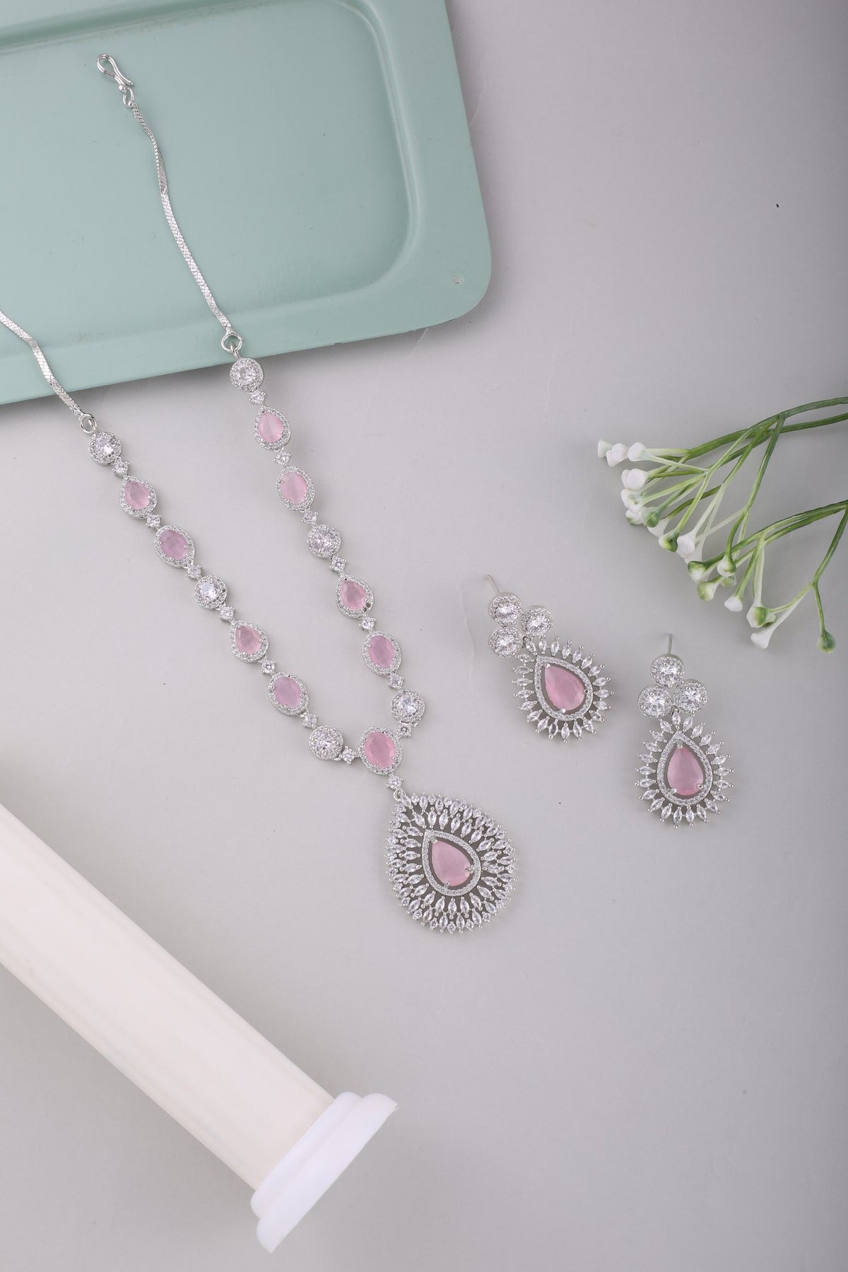 Pink American Diamond Teardrop Pendant Necklace Set, styled flat lay