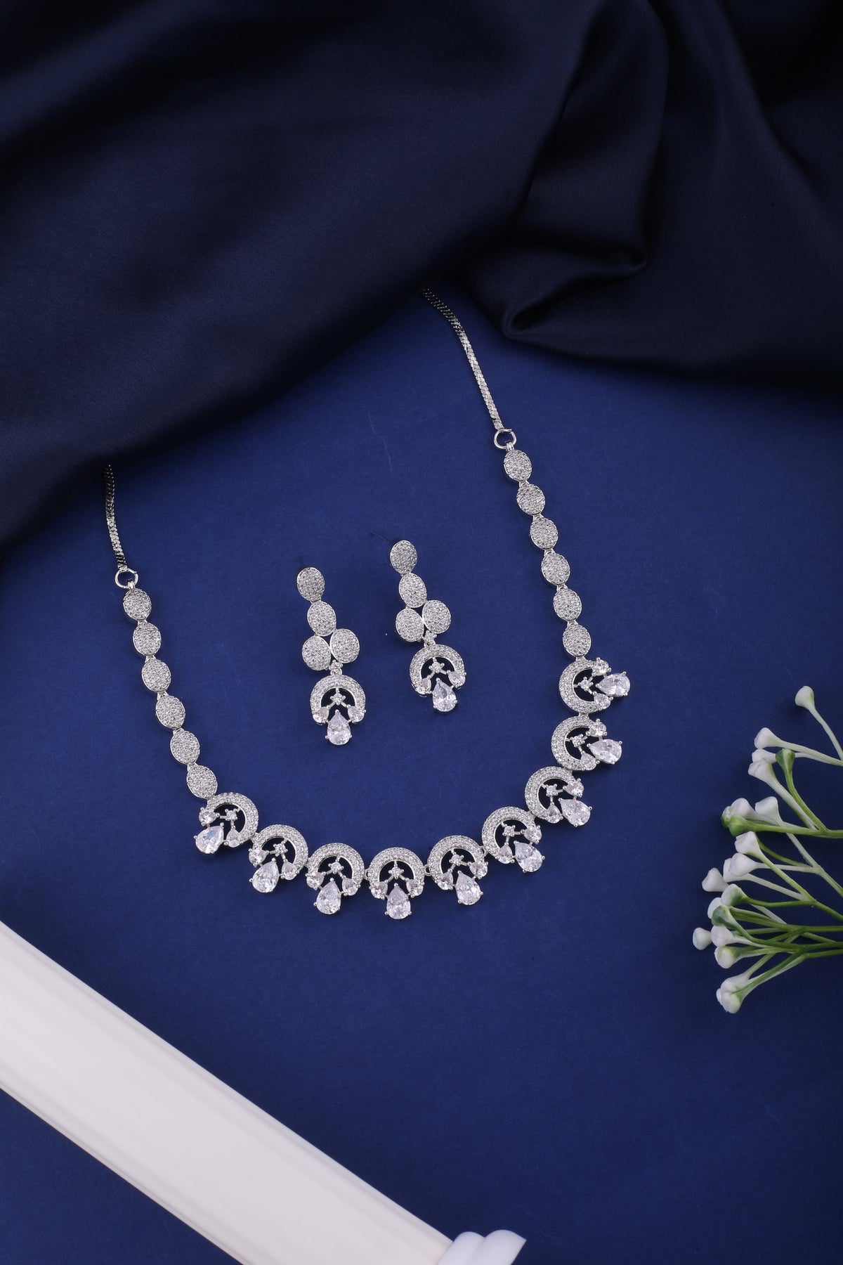American Diamond Swirl Necklace Set with Drop Earrings, styled flat lay