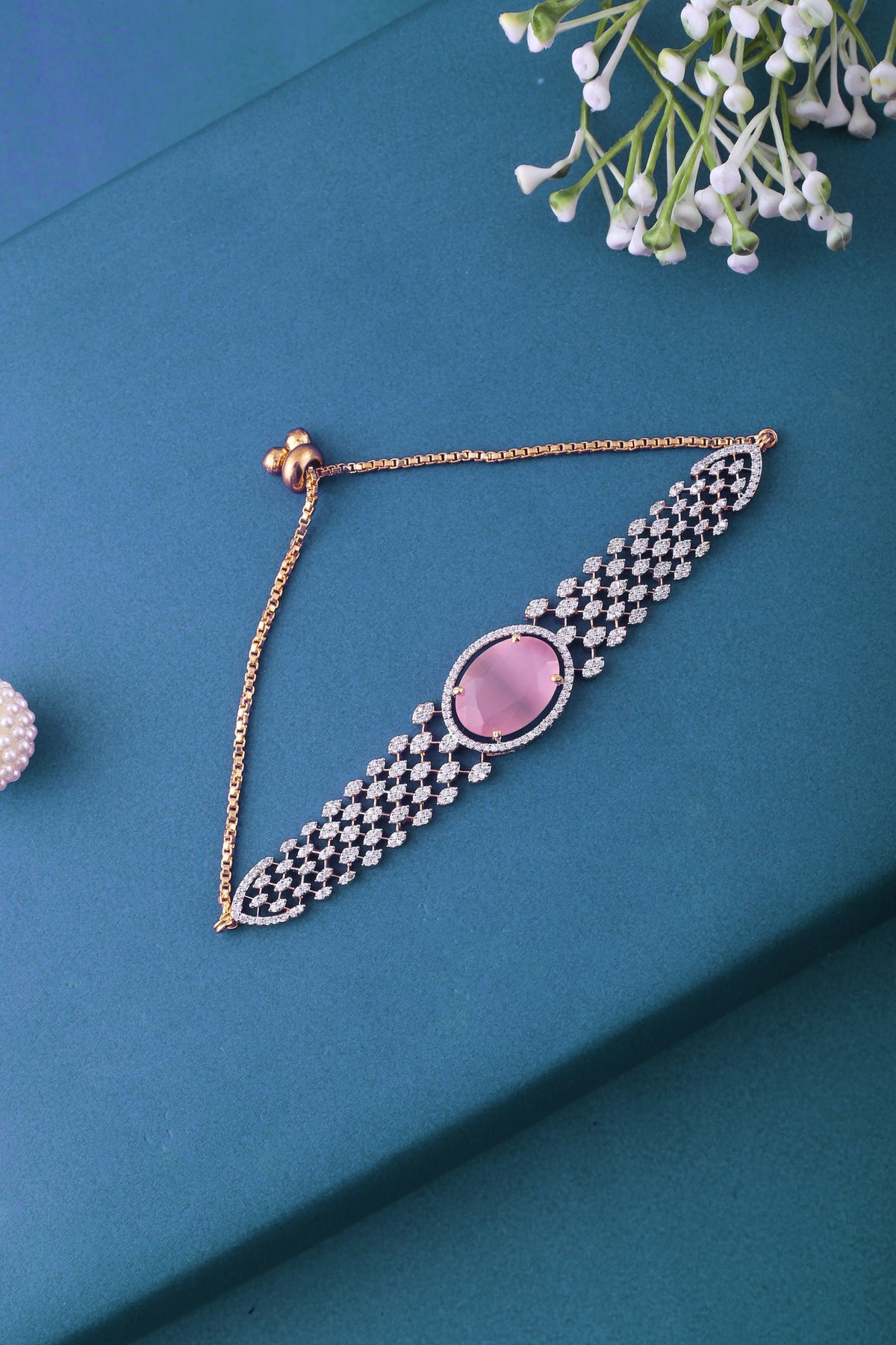 Adjustable Cubic Zirconia Bracelet with Oval Stone - Pink, styled flat lay