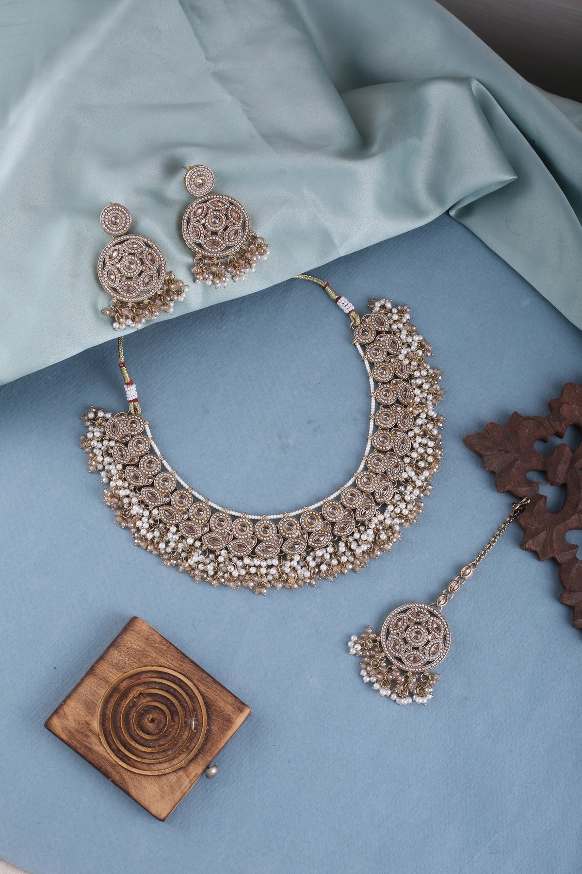 Antique Gold Pearl Cluster Choker Set with Chandbalis &amp; Maang Tikka, styled flat lay