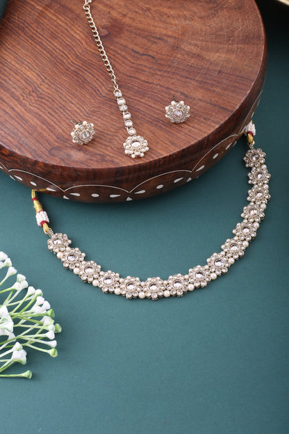 Champagne Polki Floral Necklace Set with Studs &amp; Maang Tikka, styled flat lay