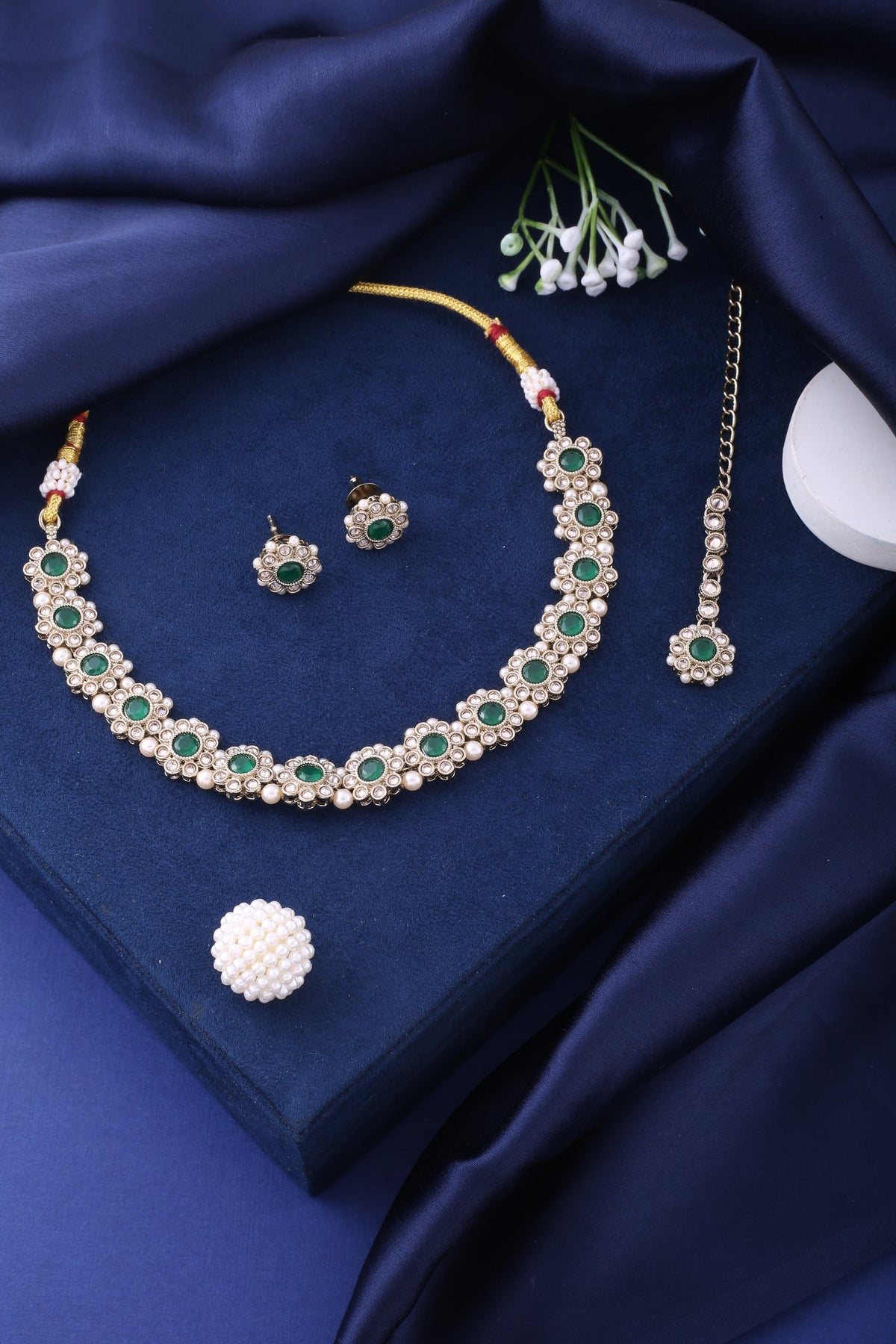 Emerald Green Polki Floral Necklace Set with Studs &amp; Maang Tikka, styled flat lay