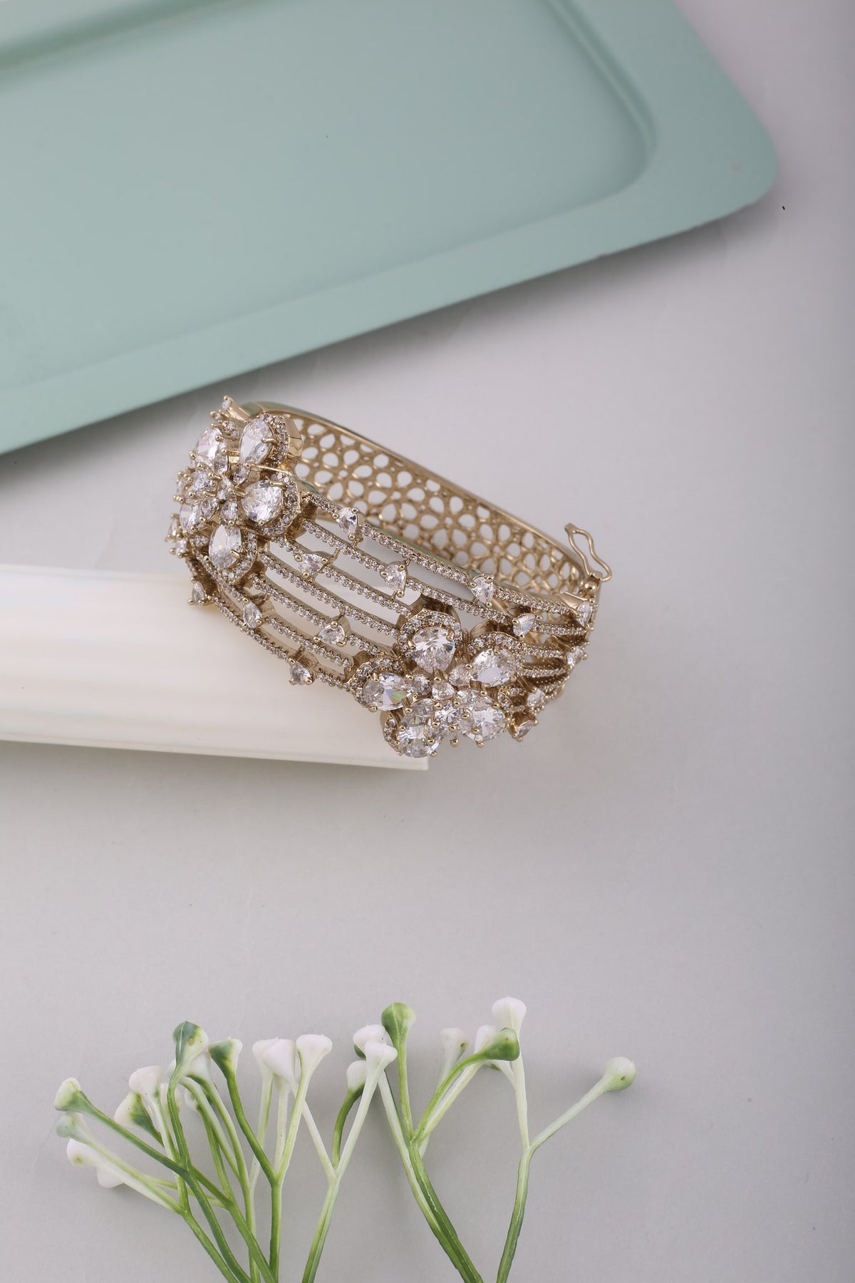 Antique Gold American Diamond Floral Kada, styled flat lay