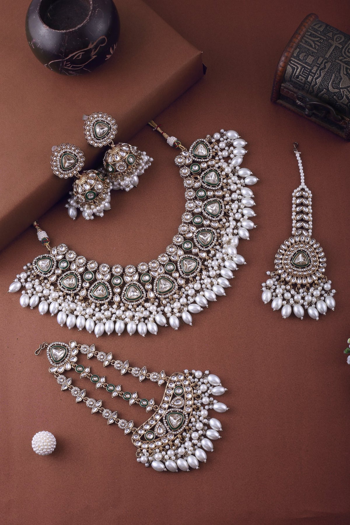 Pearl Polki Bridal Choker Set with Jhumkas, Maang Tikka &amp; Passa, styled flat lay