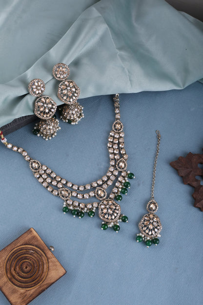 Emerald Green Three Layer Polki Necklace Set with Jhumkas &amp; Maang Tikka, styled flat lay