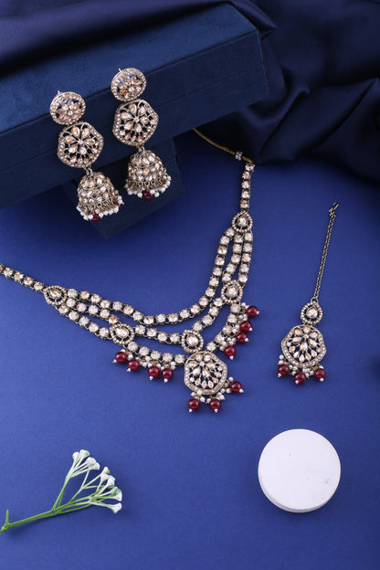 Ruby Red Three Layer Polki Necklace Set with Jhumkas &amp; Maang Tikka, styled flat lay